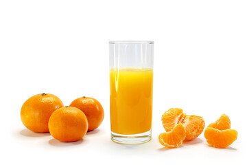fresh orange juice, tangerine juice in a glass and tangerines on a white background