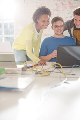 Business people using laptop in office