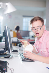 Businessman eating Chinese food at desk