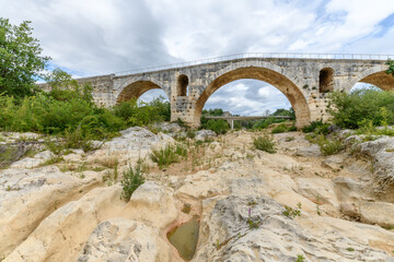 Fototapeta na wymiar The Julien bridge, Roman bridge over the Calavon river. Roman bridge in the Luberon located on the Via Domitia.