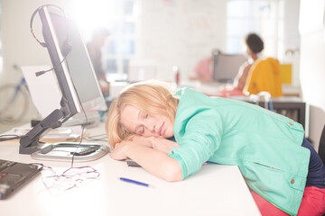 Businesswoman sleeping at desk