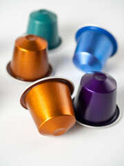 Colorful aluminum capsules with ground coffee on a white background. Capsules for the coffee machine