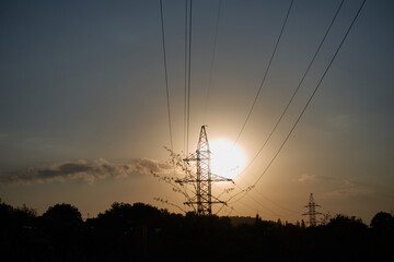 Support of high-voltage wires at sunset.