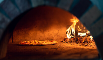 Baking pizza in a traditional wood-fired oven.
