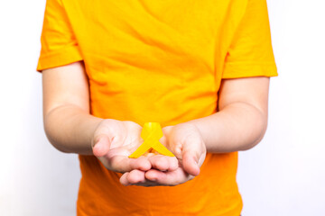 boy holding yellow ribbon in his hands, childhood cancer, white background