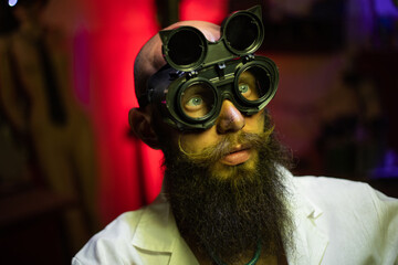 Portrait of a mad bearded doctor in a dark laboratory. Steampunk.