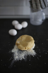 Portion of dough and flour on the kitchen table