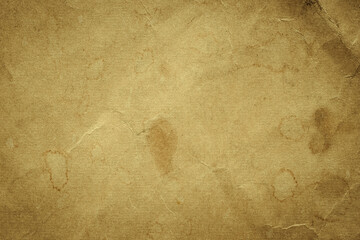 Photo of the background of an old yellowed paper with spots and cracks