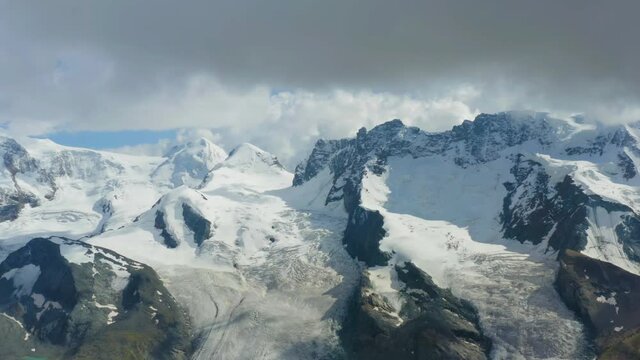 Aerial view of Monte Rosa massif, flanked by glaciers, is the highest mountain in the Swiss Alps. It has ten 4000m peaks. The Dufourspitze on the Monte Rosa massif is the highest peak in Switzerland.