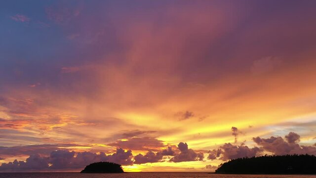 aerial view Scene of Colorful romantic sky sunset with Changing the color of the sky background. .beautiful golden sky at sunset over Pu island at Kata beach Phuket in nature and travel concept.