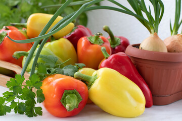 Sweet red pepper in a wooden tray on a white table