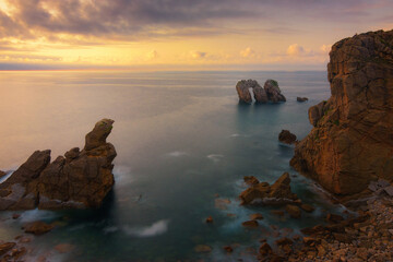 sunset coastal scenery with rock formations at the Costa Quebrada of Cantabria, Spain