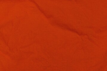 red fabric texture from a piece of crumpled matter on cloth