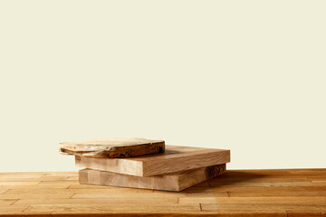 Wooden pedestal on the table, earth color background in autumn mood 