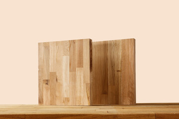 Wooden pedestal on the table, earth color background in autumn mood 