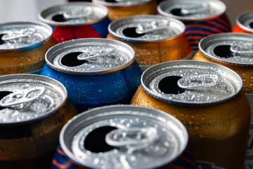 Beer cans. Aluminum cans. Close-up of many multicolored empty cans with condensation drops. Recycling and reuse. Selective focus.