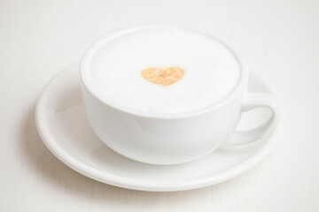 cup of cappuccino with heart foam art