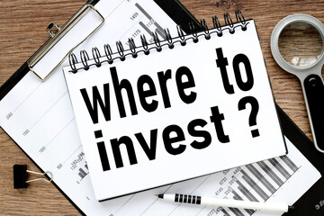 WHERE TO INVEST? text on wood table, on white paper