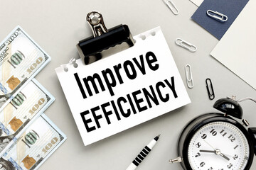 Improve Efficiency. text on white paper on gray background near money.