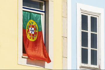 beautiful flag of portugal hanging on a window of a house in Lagos, Algarve, Potzugal