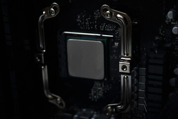 Silver computer processor on a black motherboard