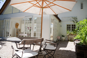 Chairs and table under umbrella in backyard