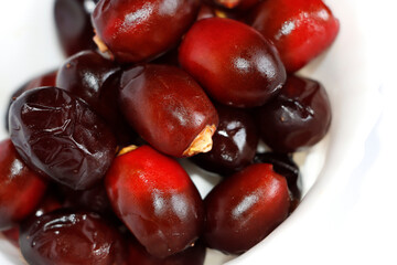 Arabic Dark Red Date Palm Fruits In White Background. Selective Focus