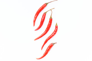 Red fresh chili peppers on white background, in the centre, flat lay, copy space, top view.