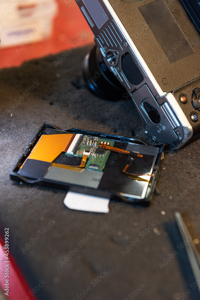 Aufkleber vertical close-up shot of a printed circuit of a disassembled camera in the technical service.