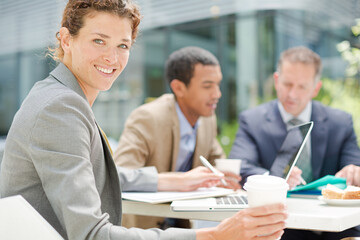 Fototapeta premium Businesswoman smiling in meeting outdoors