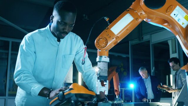 African-american engineer is studying robotic mechanism