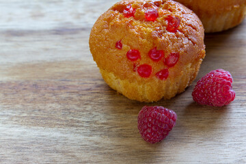 Gluten free almond flour cupcake, muffins with raspberries. Copy space, light wooden background