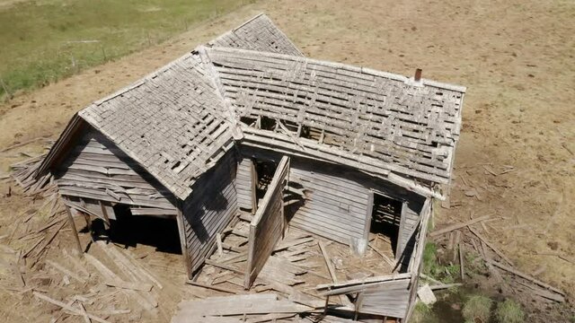 Aerial: Abandoned haunted farm house on a ranch, Ukiah, Oregon, USA