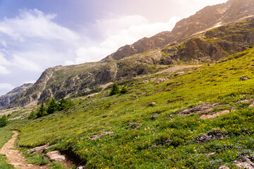 Fototapeta na wymiar Panoramic beautiful alpine landscape in summer. Sunset in french alps. High plateau in mountains.