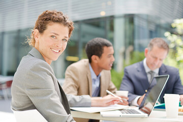 Fototapeta premium Businesswoman smiling in meeting outdoors