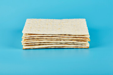 Matzah lies in an even stack on a blue background