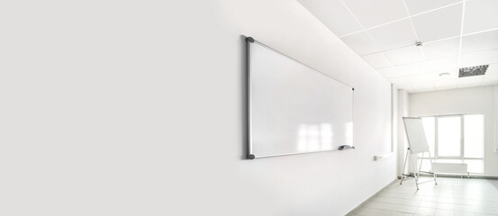 Empty training seminar room with large white chalkboard