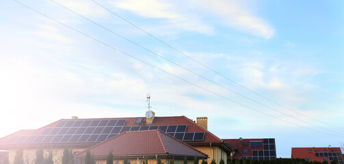 Panele fotowoltaiczne, panele słoneczne na dachach domków jednorodzinnych, fotowoltanika. - obrazy, fototapety, plakaty