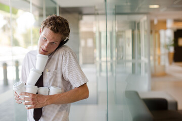 Fototapeta premium Businesswoman balancing coffee cups in office