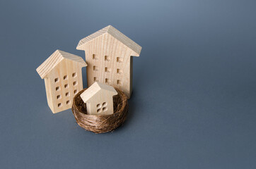 Big houses and small house in the bird nest. Parenting metaphor. Investing in real estate. Construction industry, development. Design project. Realtor services. Mortgage. Affordable social housing