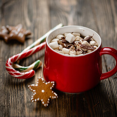 Hot chocolate with marshmallows in the red cup on the wooden cutting board. High quality photo