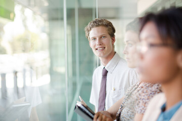 Fototapeta premium Business people looking out office window