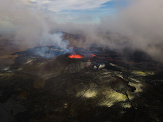 Fototapeta premium Impressive aerial view of the exploding red lava from the Active Volcano in Iceland