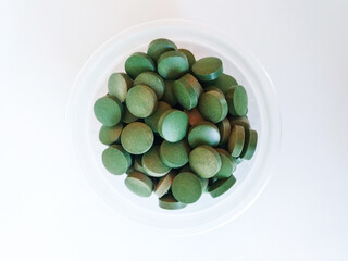green pills on white background