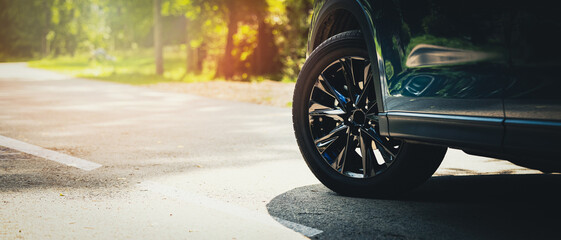 sport car with black alloy wheels on asphalt road. copy space - obrazy, fototapety, plakaty