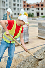 Industrious male worker digging the ground with a spade
