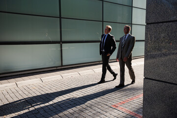 Businessmen walking on city street