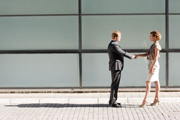 Fototapeta premium Business people shaking hands outdoors