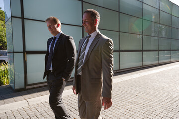 Businessmen walking on city street