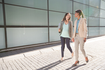 Businesswomen walking on city street